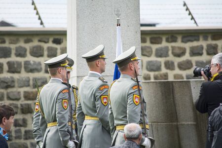 Mauthausen, Austria-May 10.2015: military celebration of the Mauthausen camp liberation by all the countries involved paying tribute to the fallen through military parades and floreal wreaths on monuments during a sunny day.のeditorial素材