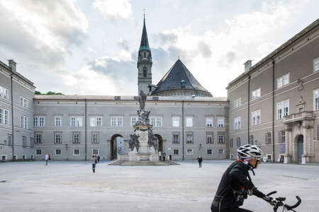 Salzburg,austria-may 10,2015:Cyclists in the square watching the city of Salzburg. during a sunny day.のeditorial素材