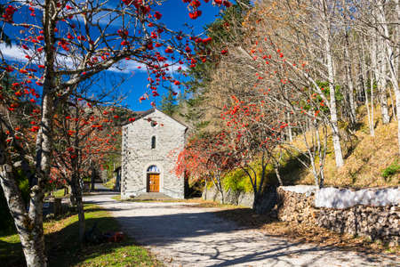 an old church in the italy forest in an sunny autumn day .の写真素材