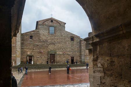 Montepulciano,Italy-April 23,2016:people stroll under the rain in the town square of Montepulciano during a cloudy day.のeditorial素材