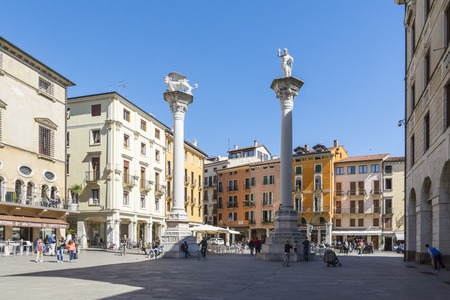 Vicenza,Italy-April 3,2015:people walk and admire  the famous town square  named Piazza dei Signor in Vicenza, Italy during a sunny day.The tower was build by famous architect Andrea Palladio.のeditorial素材