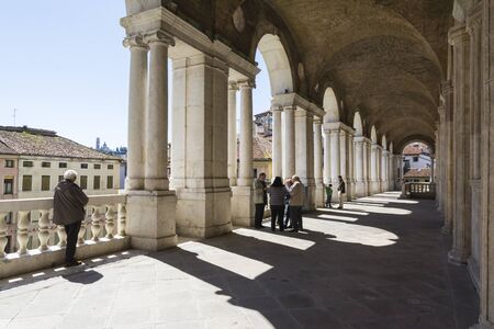 Vicenza,Italy-April 3,2015:people on  the  famous colonnade of the Palladian basilica in the center of Vicenza during a sunny day.のeditorial素材