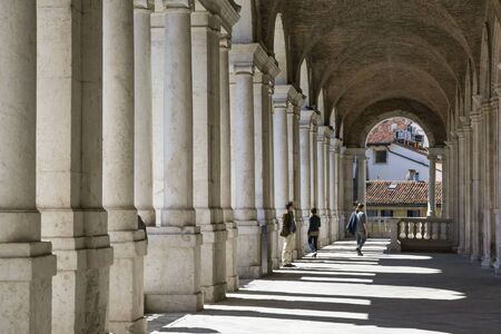 Vicenza,Italy-April 3,2015:people on  the  famous colonnade of the Palladian basilica in the center of Vicenza during a sunny day.のeditorial素材