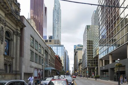 Toronto,Canada-august 1,2015:people and cars pass through Toronto and its skyscrapers to get to work or pleasure during a cloudy day.のeditorial素材