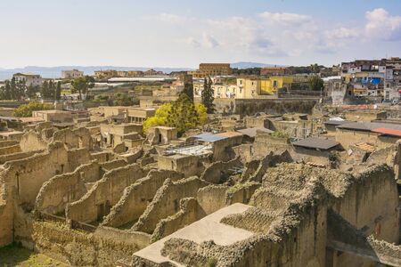 Ercolano, Italy- March 26, 2016: Herculaneum archeological site hentrance and view of the "new" town on background.の写真素材
