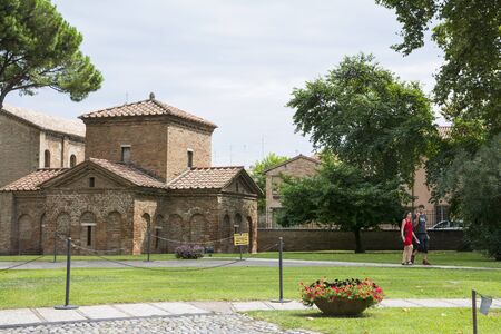 Ravenna,Italy-august 21,2015:couple stroll near the Galla Placidia mausoleum from the San Vitale garden's during a cloudy day.のeditorial素材