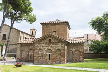 Ravenna,Italy-august 21,2015:couple stroll near the Galla Placidia mausoleum from the San Vitale garden's during a cloudy day.のeditorial素材