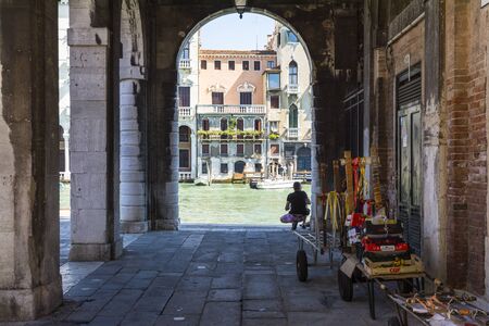 Venice,Italy-August 17,2014:view of hte man looking the  Grand canal by the arcade near the Rialto bridge during a sunny day.のeditorial素材