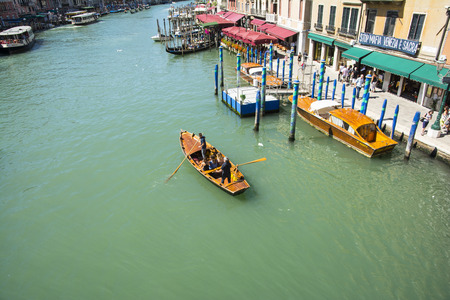 Venice,Italy-August 17,2014:View of a rowing boat with tourists on the Grand Canal of Venice during...