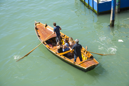 Venice,Italy-August 17,2014:View of a rowing boat with tourists on the Grand Canal of Venice during a summer day.のeditorial素材