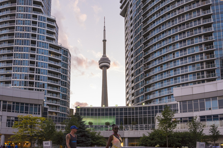 Toronto,Canada-august 2,2015:Urban life  near the CN tower in Toronto during a sunset from one of the central street of the cityのeditorial素材