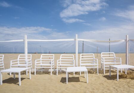 Rimini,Italy-April 17,2015:chairs and beach chairs on Rimini beach during a sunny dayの写真素材