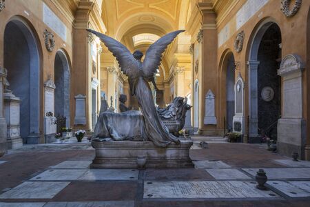 Bologna,Italy-december 7,2016:Old statue of angel on a tomb  inside the monumental cemetery of the Certosa di Bologna during a sunny day.のeditorial素材