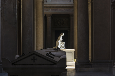 Bologna,Italy-december 7,2016:Statue of woman praying inside monumental cemetery of the Certosa in Bologna during a sunny day.のeditorial素材