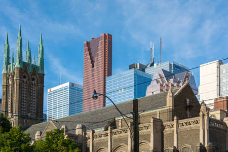 Toronto,Canada-august 2,2015: church and skyscrapers on the streets of the suburbs of Toronto during a sunny dayのeditorial素材