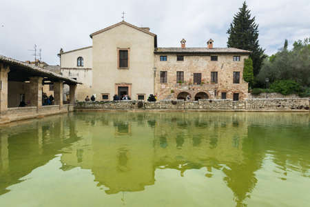 Bagni Vignone,Italy-April 25,2016:People visit the little town in tuscany,Italy famous for the sulphurous hot springs during a cloudy day.のeditorial素材