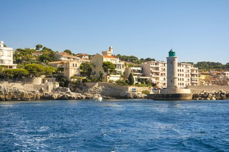 Cassis,France-august 10,2016:The port of Cassis, a French village with colorful boats moored and the lighthouse during a summer day.のeditorial素材