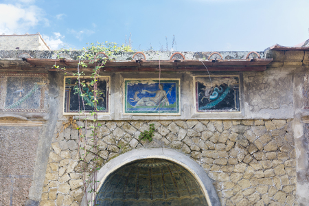 Ercolano, Italy- March 26, 2016: Columns,ruins and paintings inside the Herculaneum archeological site near Naples during a summer day.のeditorial素材