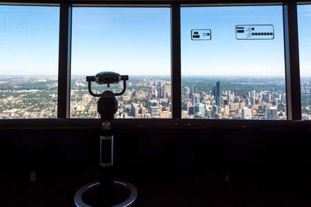 Toronto,Canada-august 2,2015:binoculars and view of Toronto city skyline from the top of the Cn tower during a sunny day.のeditorial素材