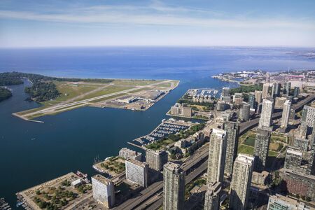 Toronto,Canada August 2,2015:aerial view of the cityscape of Toronto's Harbourfront, and Billy Bishop Airport during a sunny dayby the top of Cn tower.のeditorial素材