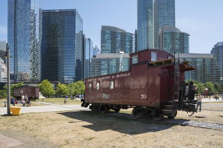Toronto,Canada-august 2,2015:people visit the  Toronto's railway heritage center with a view of skyscrapers during a sunny dayのeditorial素材