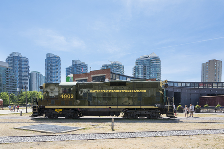 Toronto,Canada-august 2,2015:people visit the  Toronto's railway heritage center with a view of skyscrapers during a sunny dayのeditorial素材