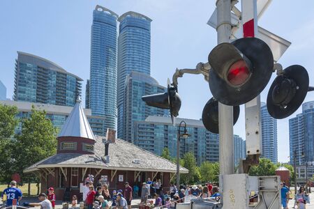 Toronto,Canada-august 2,2015:people visit the  Toronto's railway heritage center with a view of skyscrapers during a sunny dayのeditorial素材