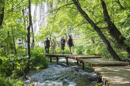 Plitvice,Croatia-june 3,2017:people on the classic wooden path over the  water in the national park of plitvice lakes in croatia on a sunny dayのeditorial素材
