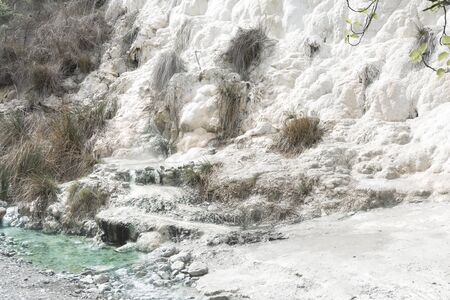 Limestone formations at the hot springs of the Bagni di San Filippo in Tuscany, Italy, during a sunny day.の写真素材