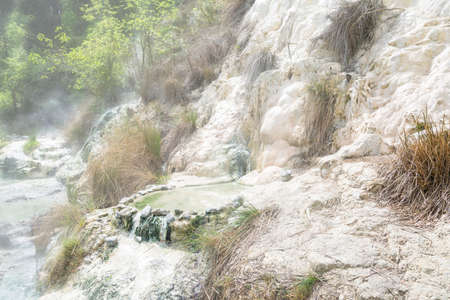 Limestone formations at the hot springs of the Bagni di San Filippo in Tuscany, Italy, during a sunny day.の写真素材