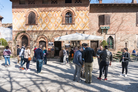 Piacenza,Italy-April 2,2018:People visit the historical village of Grazzano Visconti,neo-gothic village near Piacenza, Italy during a sunny dayのeditorial素材