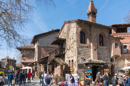 Piacenza,Italy-April 2,2018:People visit the historical village of Grazzano Visconti,neo-gothic village near Piacenza, Italy during a sunny dayのeditorial素材