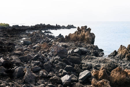 non classical view of the coast of Lanzarote formed mostly by cooled lava during a sunny day. Here we are near Punta Escamas just north of the Jameos de agua.の写真素材