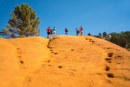 Roussilion,France-august 13,2016:tourists visiting the famous Ocra color quarries near Roussillon in France during a sunny dayのeditorial素材