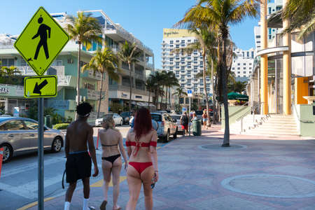 Miami,USA-march 15,2018:young people stroll along the famous Ocean drive in Miami during a sunny dayのeditorial素材