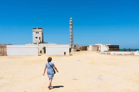 Cadiz,Spain-august 9, 2017:lady walks towards the iron lighthouse inside the San Sebastian castle in Cadiz  during a sunny dayのeditorial素材