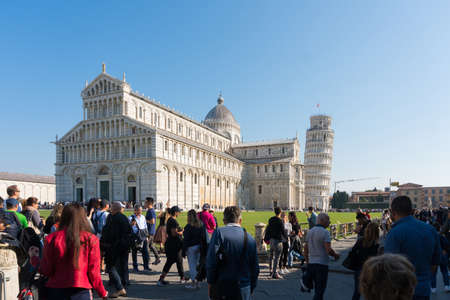 Pisa, Italy-October 21, 2018:tourists walk among the symbolic places of Pisa admiring the beauty and taking pictures during a sunny dayのeditorial素材