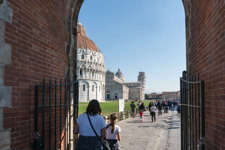 Pisa, Italy-October 21, 2018:tourists walk among the symbolic places of Pisa admiring the beauty and taking pictures during a sunny dayのeditorial素材