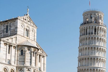 view of the famous leaning tower and the medieval cathedral located in the famous square of miracles in Pisaの写真素材