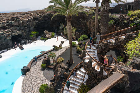 Lanzarote, Spain - August 6,2018:people at the Jameos del Agua, part of a long lava tube which formed when the Montana La Corona erupted and transformed by Cesar Manrique into a tourist attraction.のeditorial素材