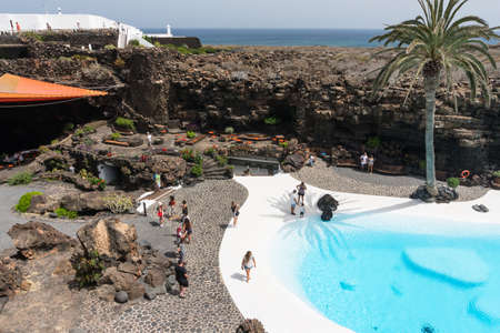 Lanzarote, Spain - August 6,2018:people at the Jameos del Agua, part of a long lava tube which formed when the Montana La Corona erupted and transformed by Cesar Manrique into a tourist attraction.のeditorial素材