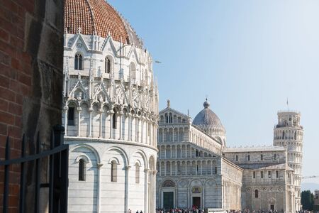 view of the famous leaning tower and the medieval cathedral located in the famous square of miracles in Pisaの写真素材