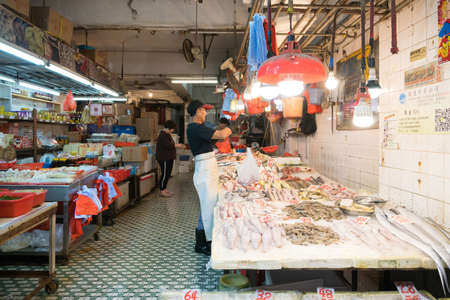 Hong Kong,March 24,2019:People among the classic markets in the narrow and crowded streets of Hong Kong during a cloudy dayのeditorial素材