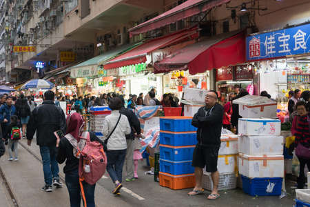 Hong Kong,March 24,2019:People among the classic markets in the narrow and crowded streets of Hong Kong during a cloudy dayのeditorial素材