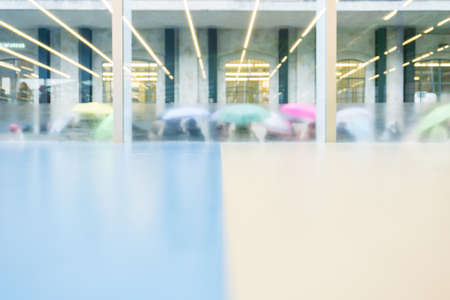 People with colorful umbrellas lined up to enter the museum of the Prada foundation in Milan during a rainy dayのeditorial素材