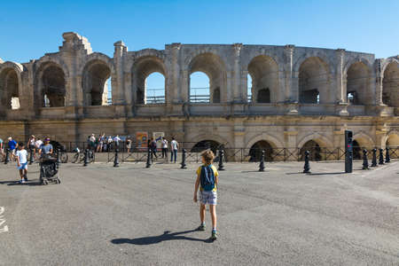 Arles,France-august 14,2016:unrecognizable child with backpack strolls near the famous arena of Arles during a sunny dayのeditorial素材