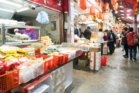 Hong Kong,March 24,2019:People among the classic markets in the narrow and crowded streets of Hong Kong during a cloudy dayのeditorial素材