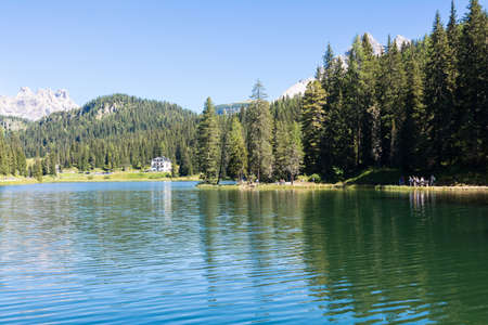 Misurina, Italy - August 23, 2016:people walk around the lake in the heart of the Belluno Dolomites during a sunny dayのeditorial素材