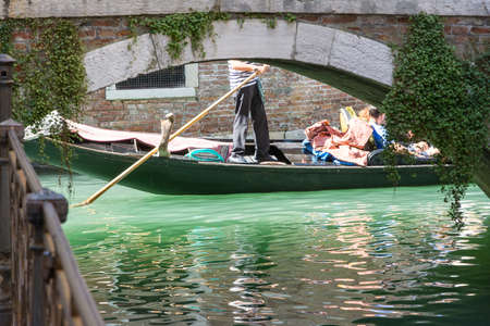 Venice, Italy-August 17,2014: This is a typical view of Venice with its canals and narrow streets full of tourists during a sunny day.のeditorial素材