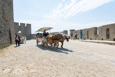 Carcassonne, France-august 15,2016: people visit the fortified city of Carcassonne on a horse-drawn carriage during a sunny dayのeditorial素材